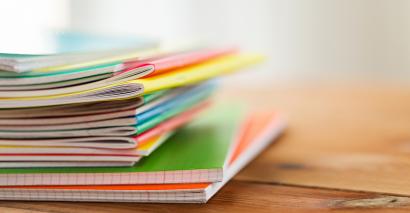 A stack of pupil exercise books belonging to french, german and spanish learners